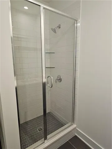 a bathroom with a glass shower door