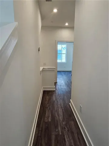 a view of a room with wooden floor and staircase