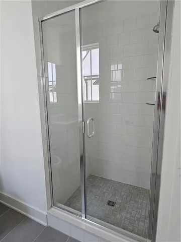 a bathroom with a glass shower door