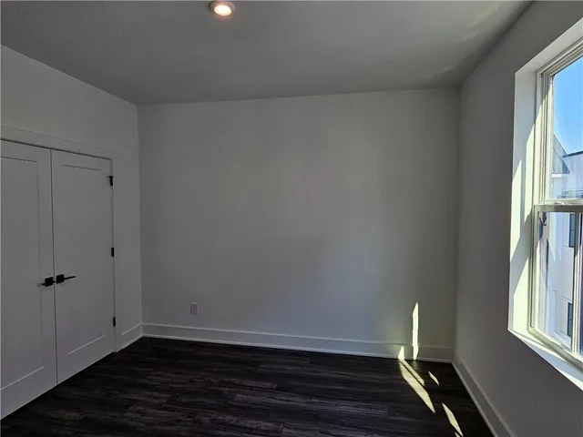 a view of room with window and wooden floor