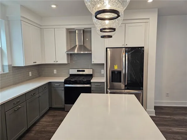 a kitchen with stainless steel appliances a stove and a refrigerator
