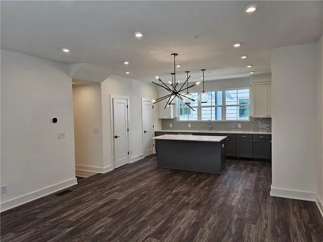 a large room with lot of counter top space and windows