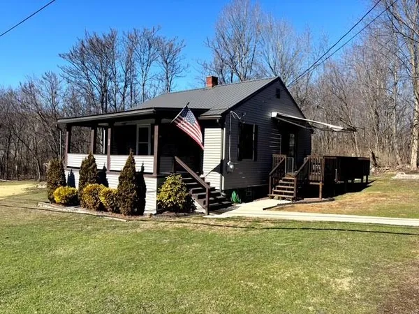 a view of a house with yard patio and wooden fence