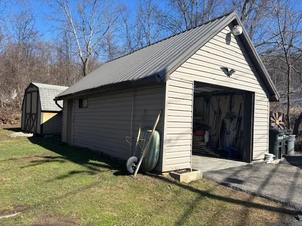 a view of house with backyard and trees