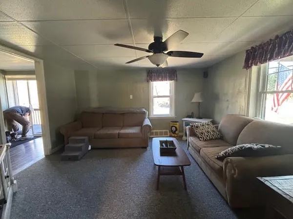 a living room with furniture and a chandelier
