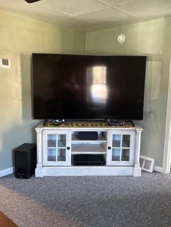 a living room with a flat screen tv and outdoor space