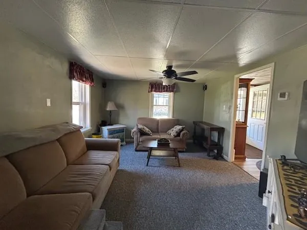 a living room with furniture and a chandelier
