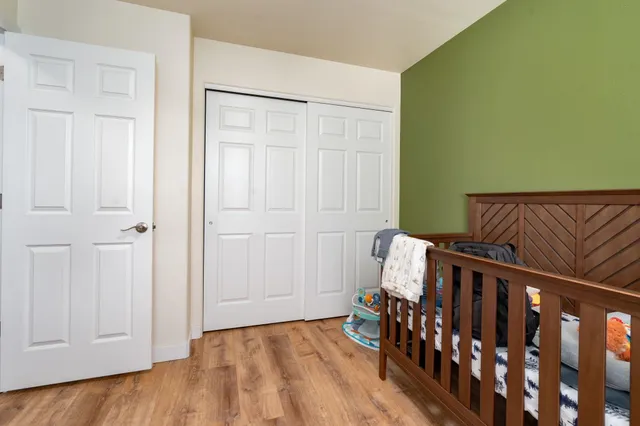 a bedroom with furniture and wooden floor