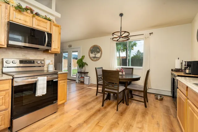 a view of a dining room with furniture wooden floor and a clock