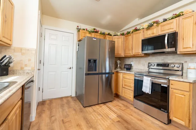 a kitchen with stainless steel appliances a refrigerator stove and microwave
