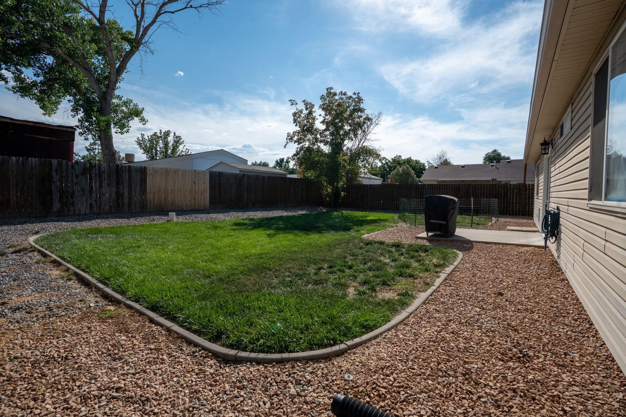 1300 Powell Street Fruita, CO 81521 - Photo 24 of 25 a view of a backyard with a garden