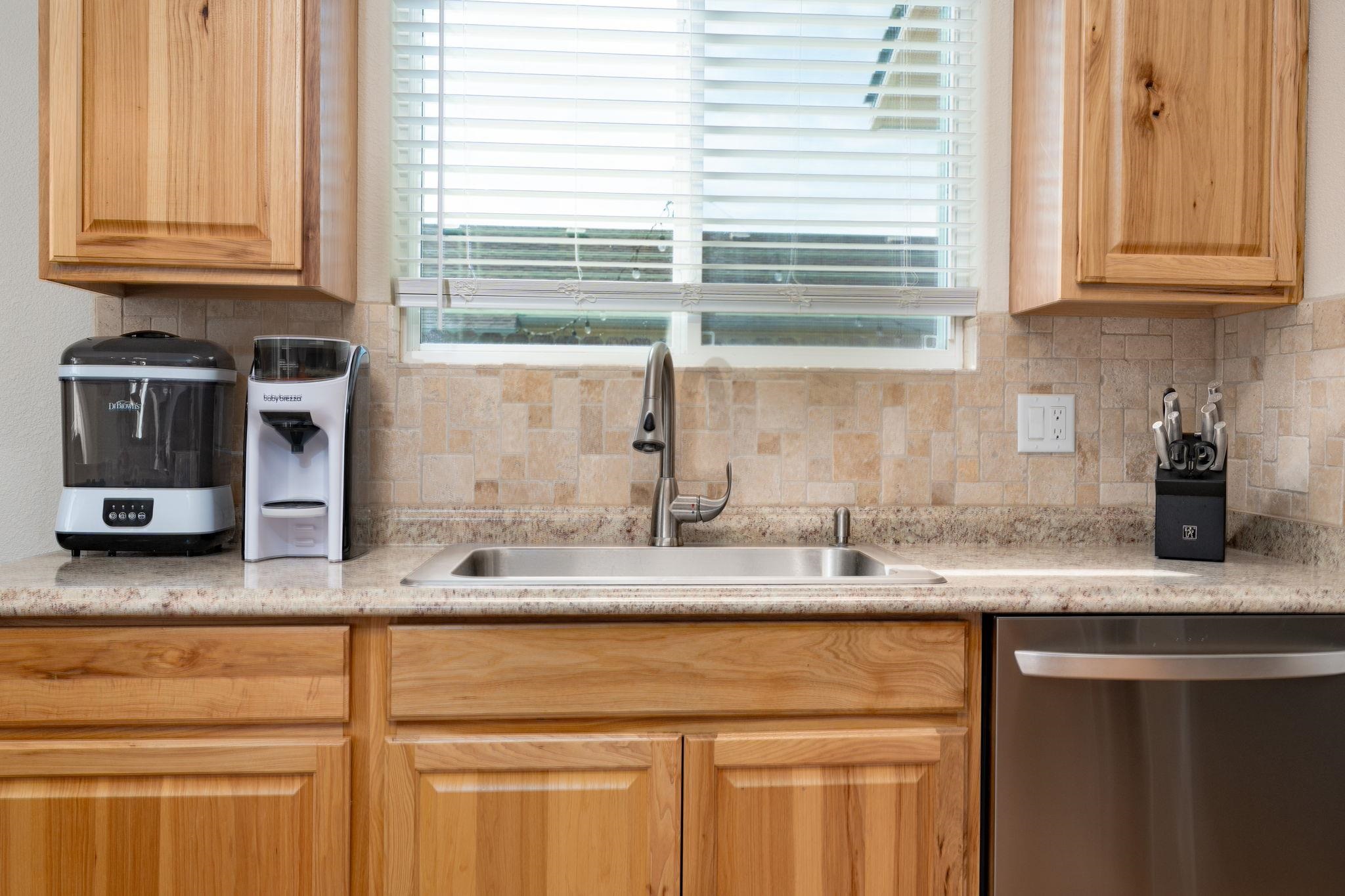 1300 Powell Street Fruita, CO 81521 - Photo 4 of 25 a kitchen with stainless steel appliances granite countertop a sink and a microwave