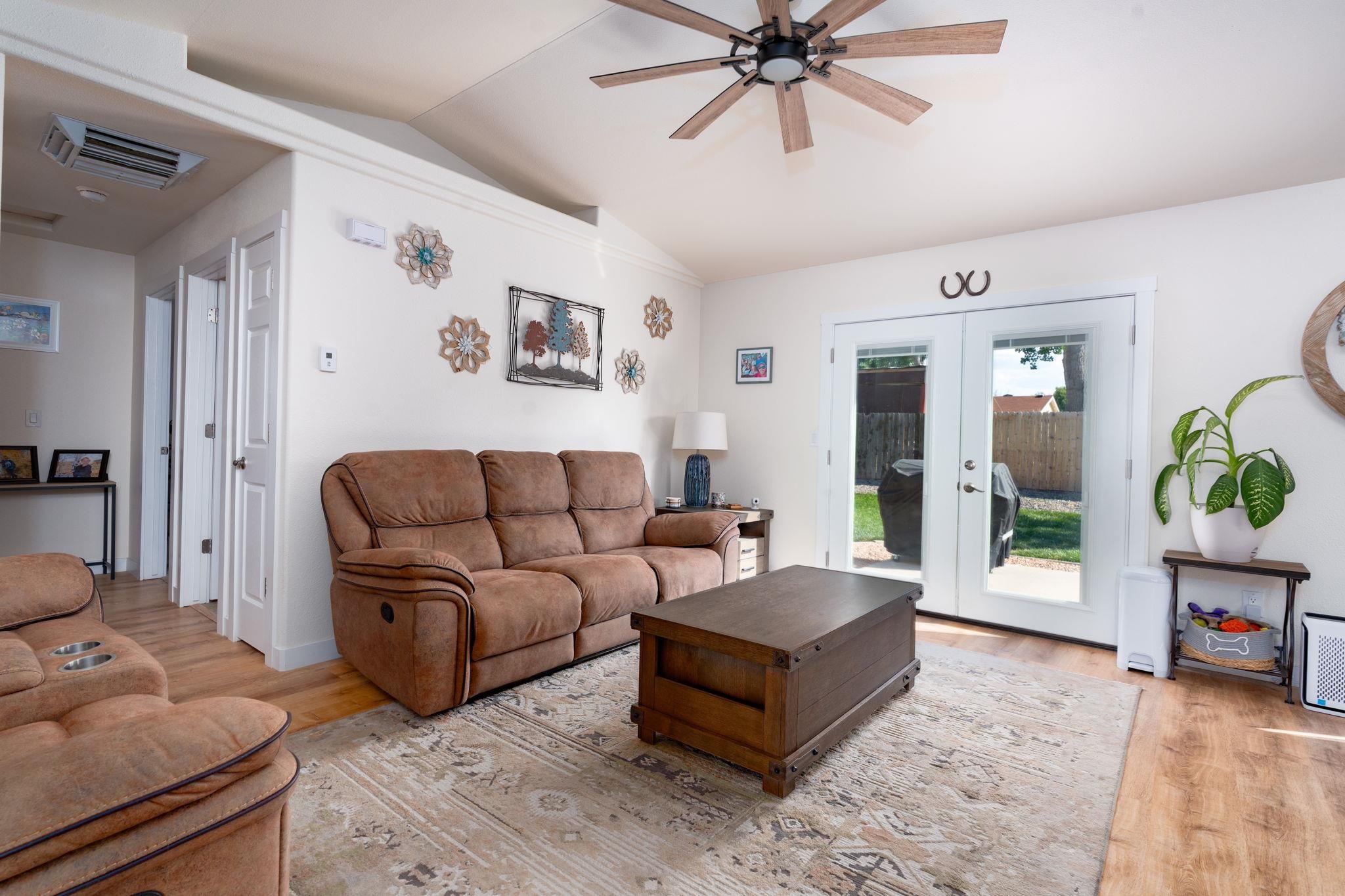 1300 Powell Street Fruita, CO 81521 - Photo 5 of 25 a living room with furniture and a wooden floor