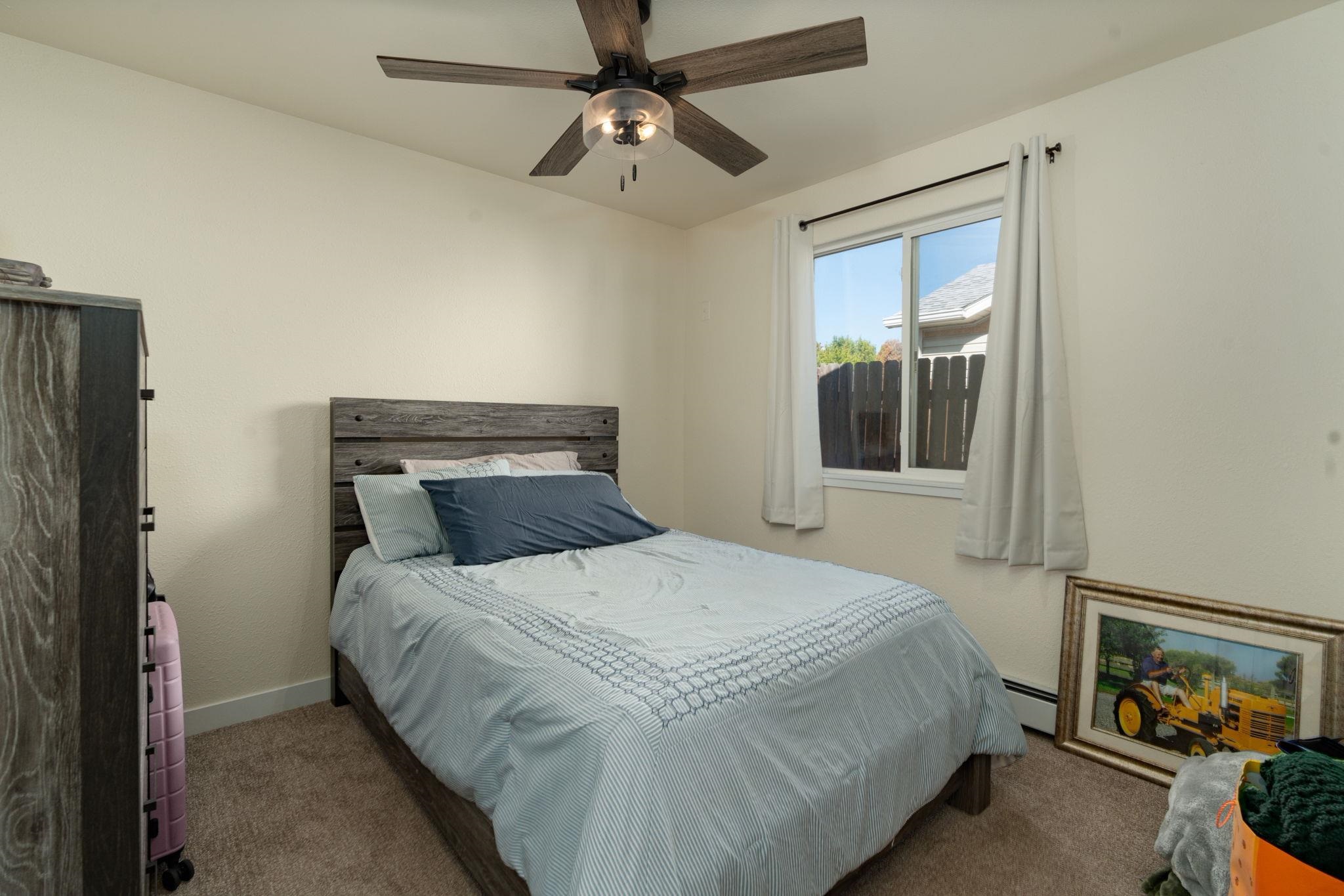 1300 Powell Street Fruita, CO 81521 - Photo 9 of 25 a bedroom with a bed and a window