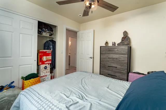 a bedroom with a bed and a chandelier