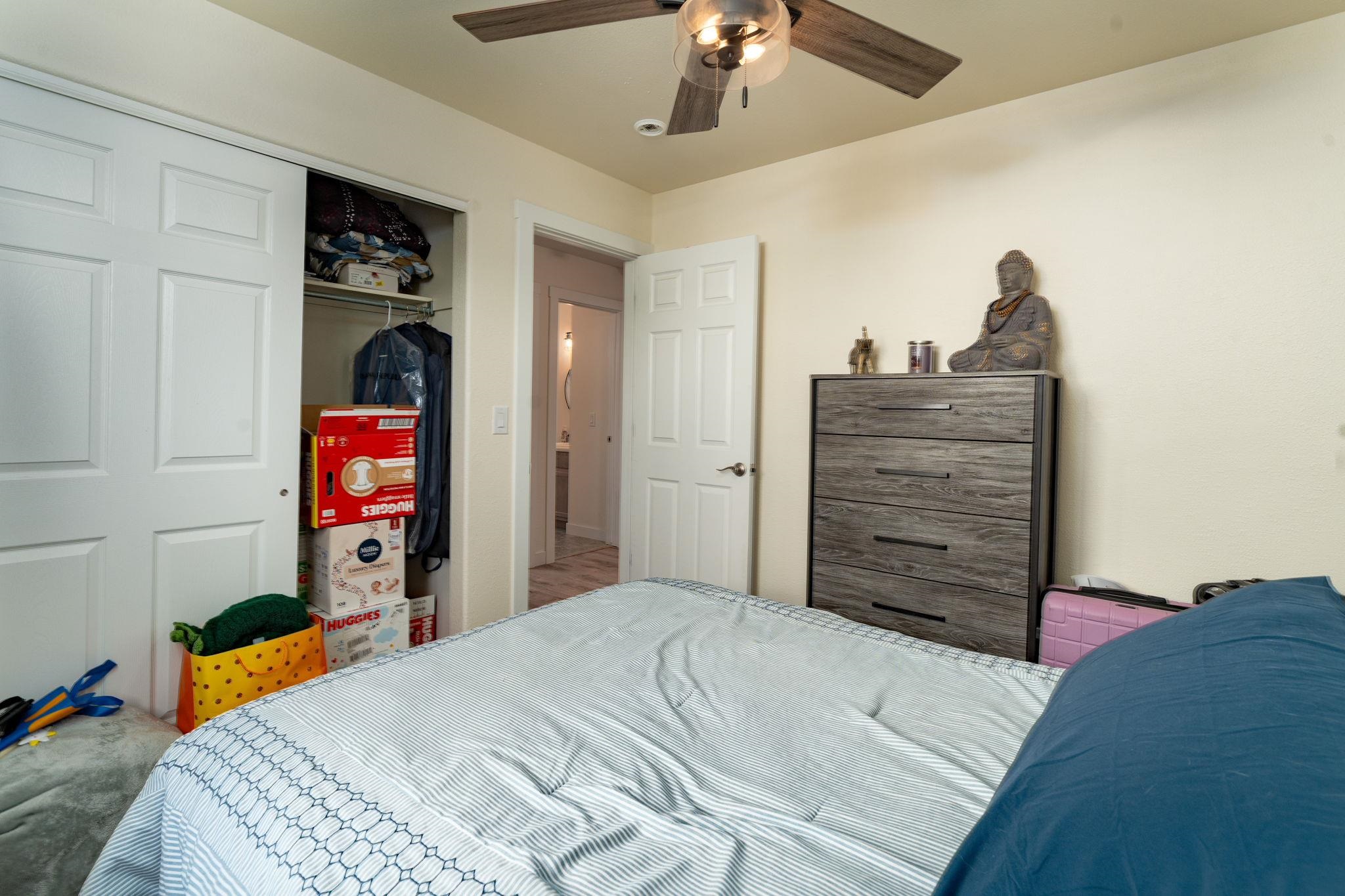 1300 Powell Street Fruita, CO 81521 - Photo 10 of 25 a bedroom with a bed and a chandelier