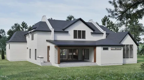 a front view of a house with a garden and plants
