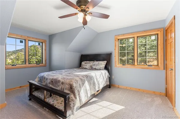 a bed sitting in a bedroom next to a window