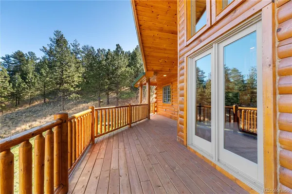a view of a balcony with wooden floor and fence