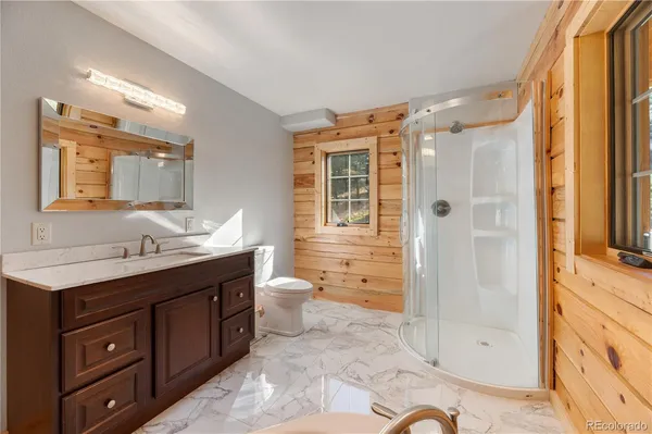 a bathroom with a sink a toilet and mirror