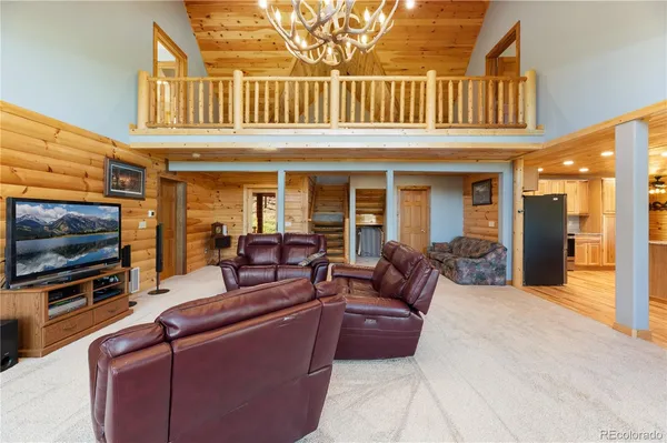 a living room with fireplace furniture and a flat screen tv