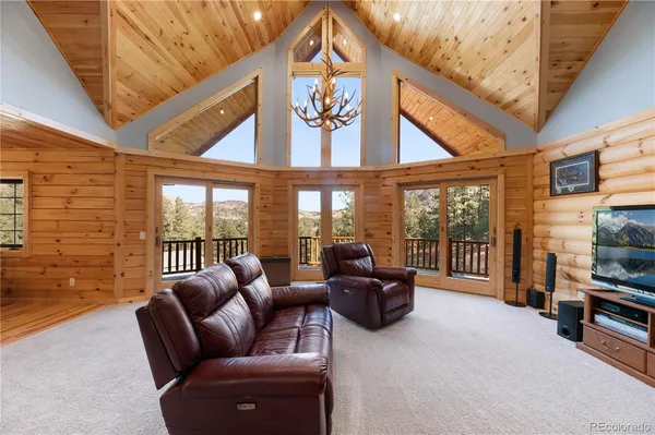 a living room with furniture a flat screen tv and a large window