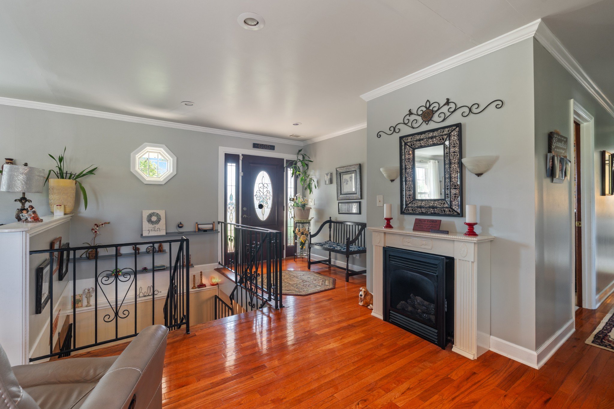 10779 North Tidwell Road Bon Aqua, TN 37025 - Photo 11 of 46 a living room with furniture a fireplace and a large mirror with wooden floor