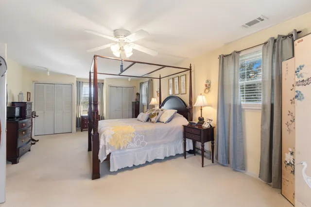 a bedroom with bed and a chandelier
