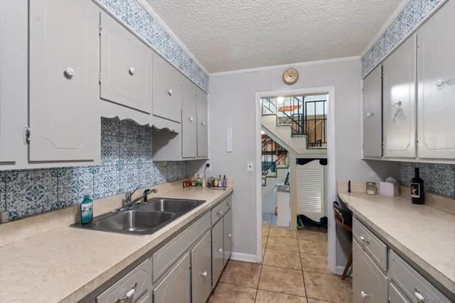 a kitchen that has a sink and a stove in it