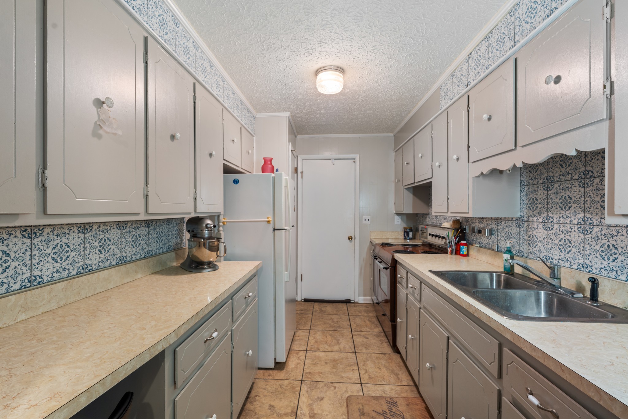 10779 North Tidwell Road Bon Aqua, TN 37025 - Photo 22 of 46 a kitchen with a sink stove and cabinets