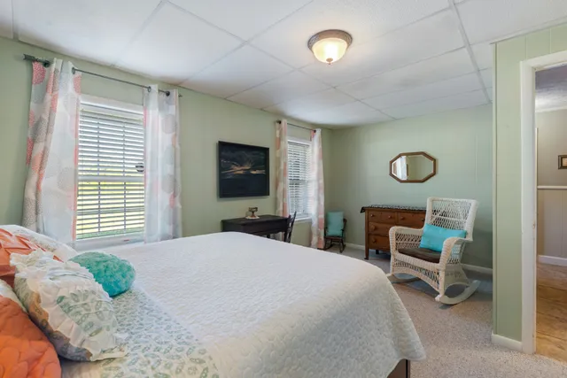 a bedroom with a large bed and a flat screen tv