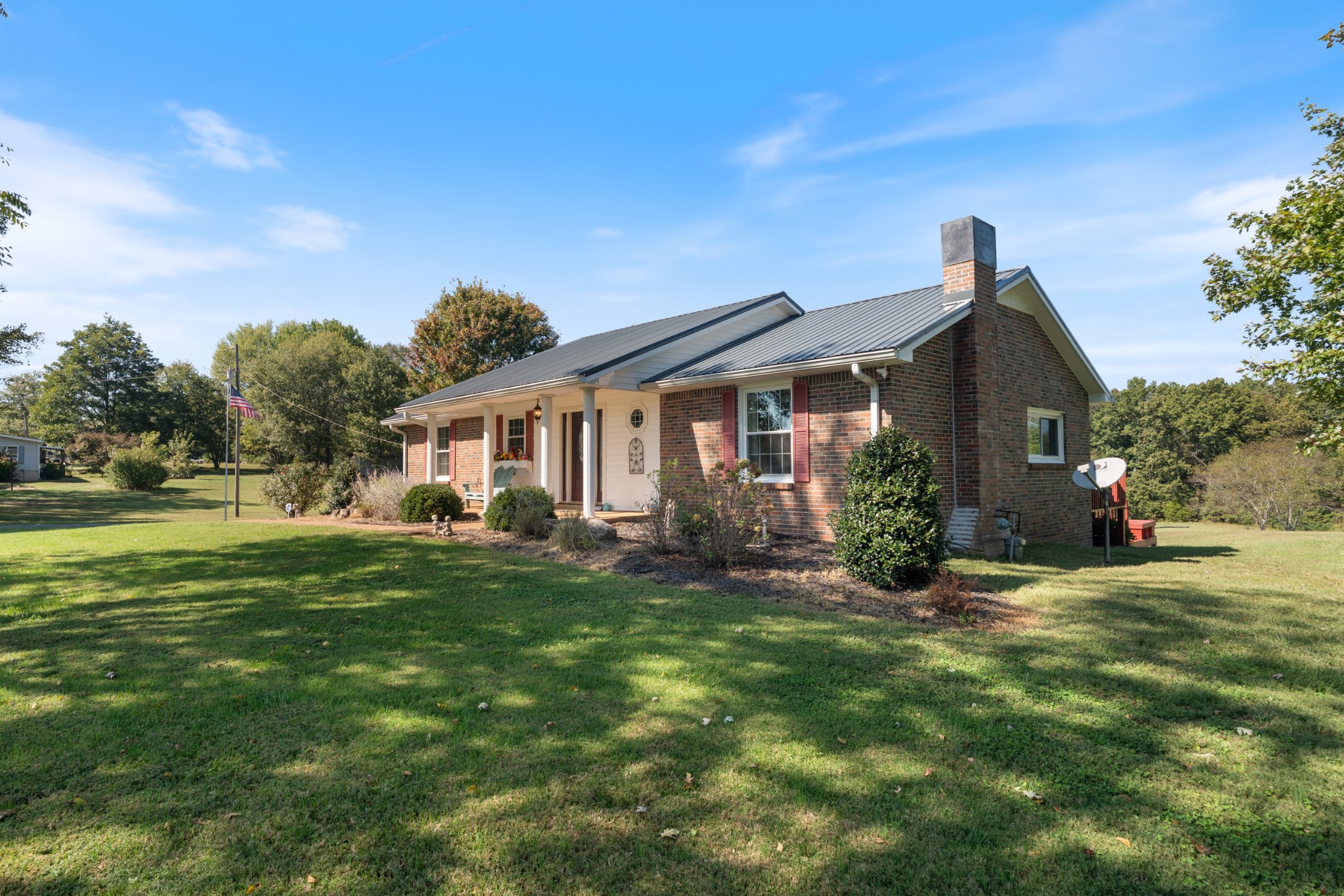 10779 North Tidwell Road Bon Aqua, TN 37025 - Photo 3 of 44 a front view of a house with a yard