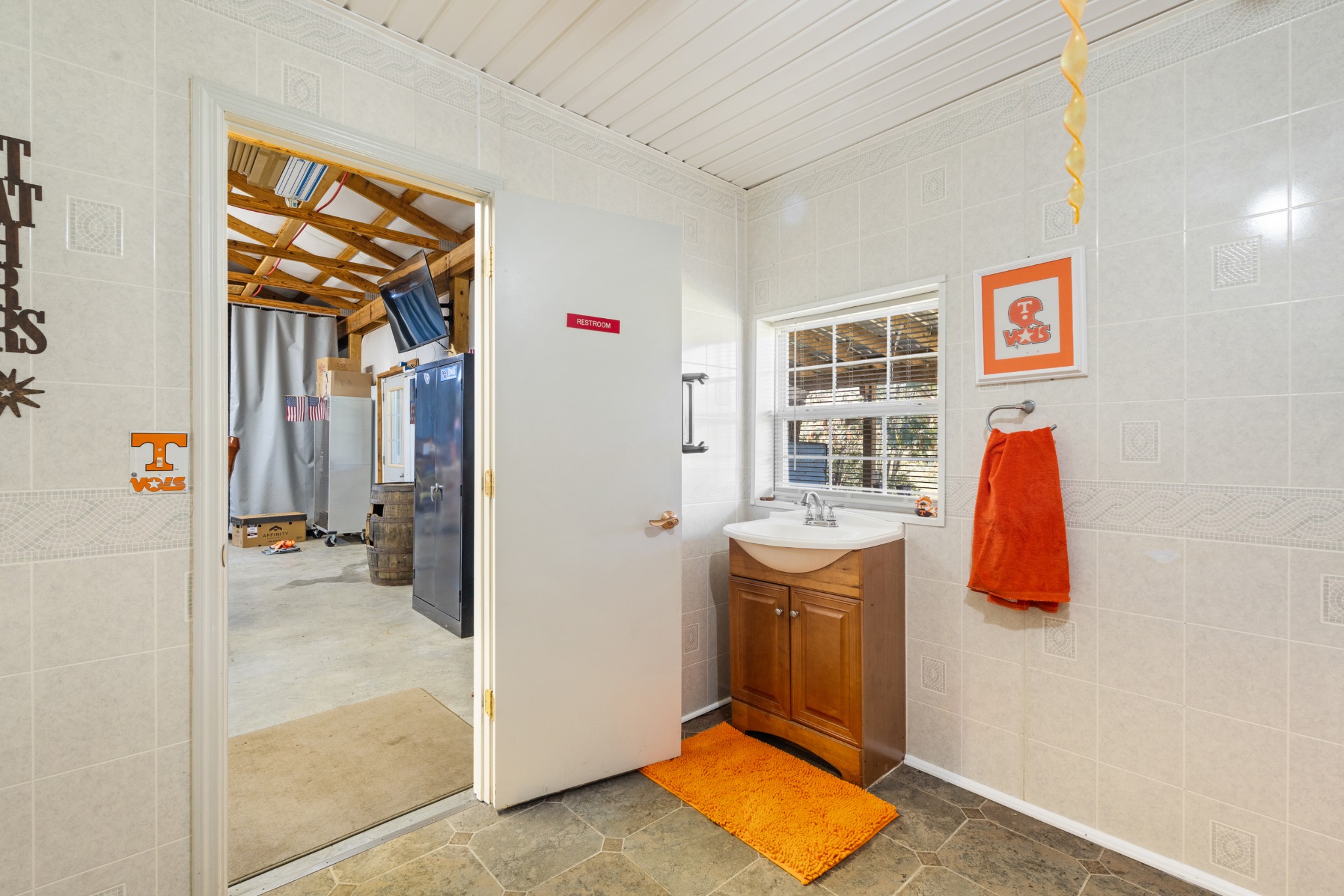 10779 North Tidwell Road Bon Aqua, TN 37025 - Photo 36 of 46 a view of walk in closet with clothes and shoes