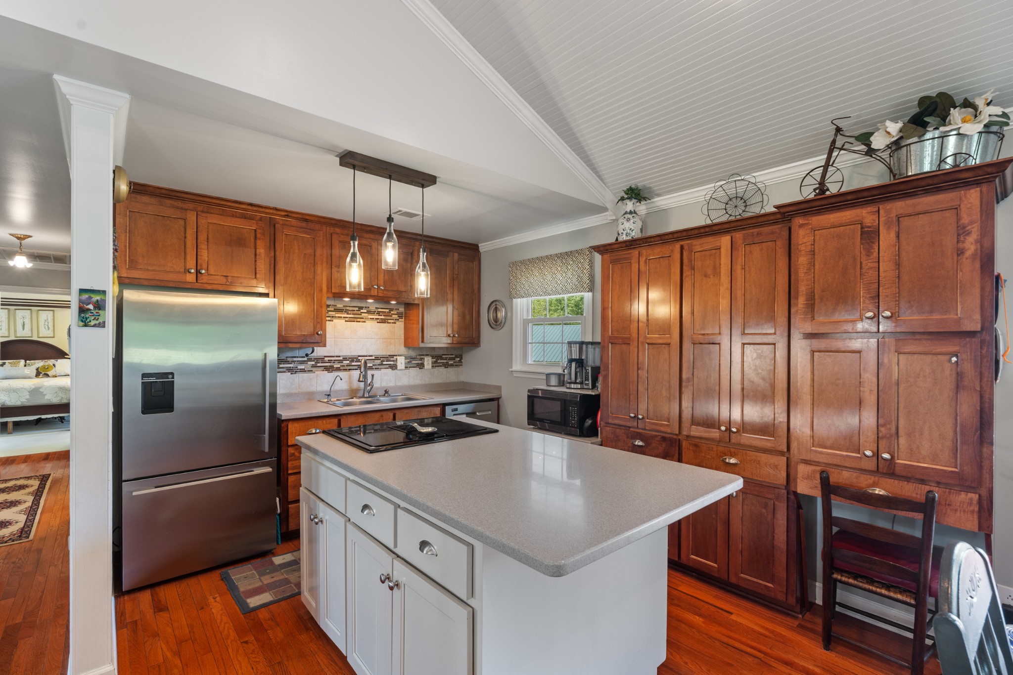 10779 North Tidwell Road Bon Aqua, TN 37025 - Photo 8 of 46 a kitchen with kitchen island granite countertop a sink appliances and cabinets