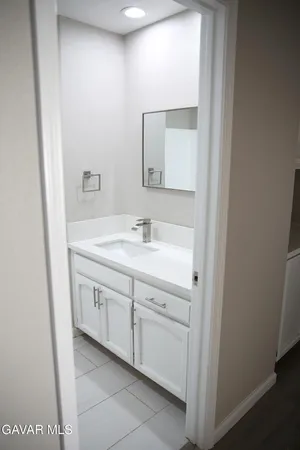 a bathroom with a double vanity sink and a mirror