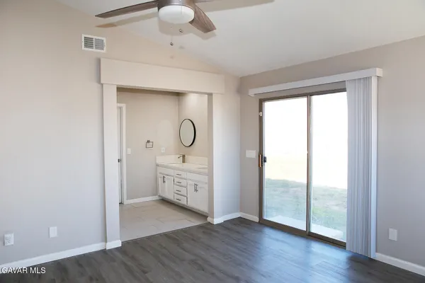 a view of a room with wooden floor and windows