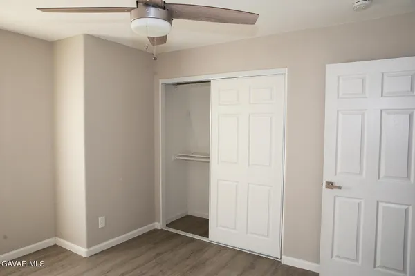 a view of an empty room and wooden floor