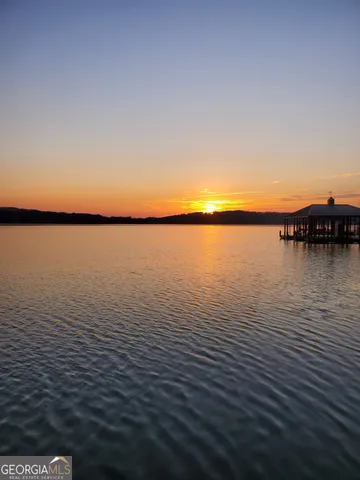 a view of a grassy field with mountains in the background