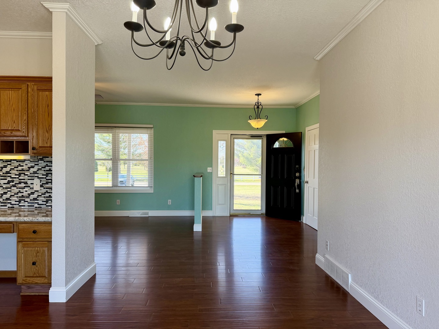 20922 Cattail Road Fulton, IL 61252 - Photo 8 of 30 a view of a hallway with wooden floor and a chandelier