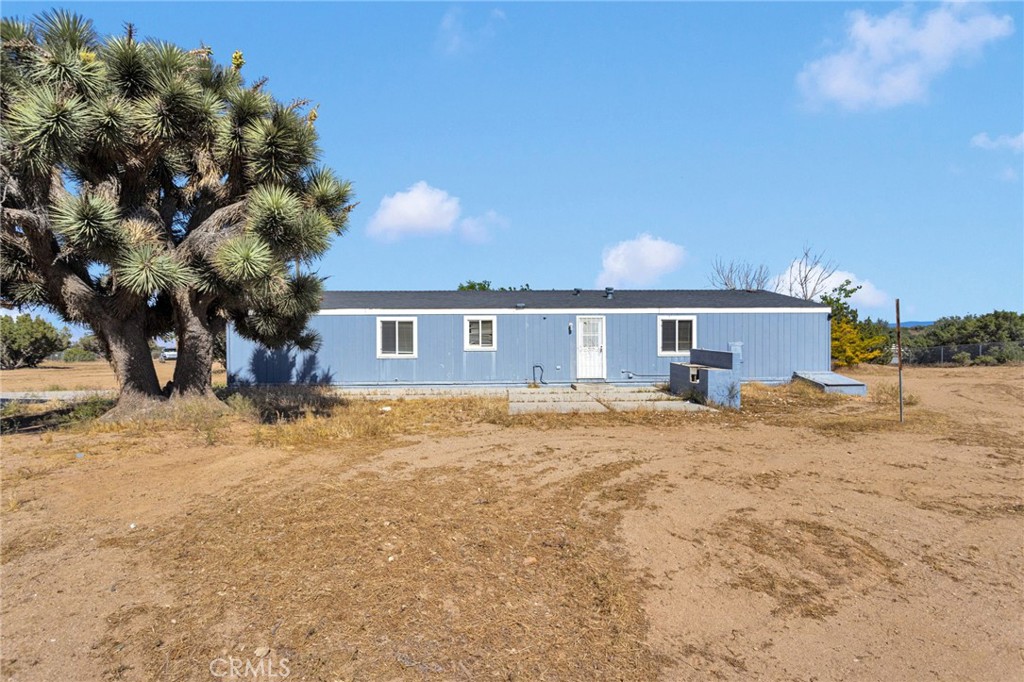 8074 Mira Mar Road Phelan, CA 92371 - Photo 38 of 49 a front view of a house with a yard