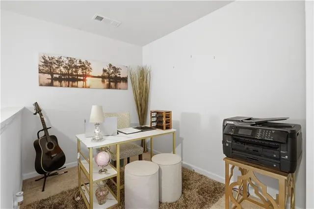 a en suite bathroom with a granite countertop sink and a mirror