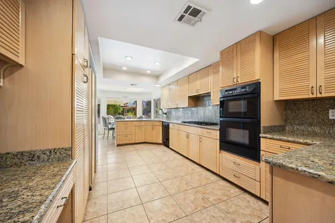 a spacious bathroom with a granite countertop sink a toilet and a bathtub