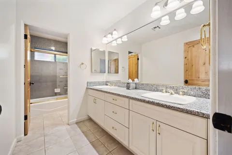 a view of a patio with table and chairs and potted plants