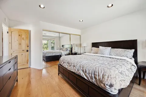 a bed room with a bed window and a table