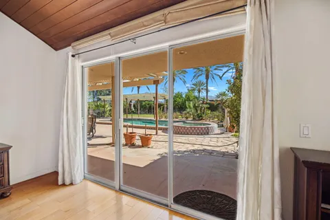 a view of a hallway with wooden floor and entryway
