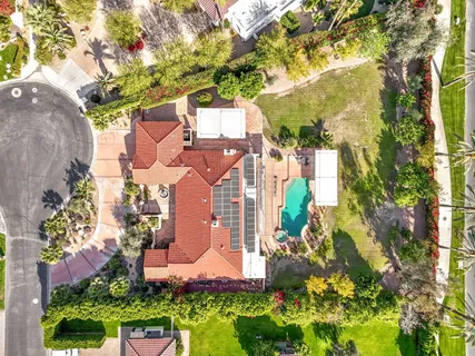 a view of a hallway with wooden floor and a living room