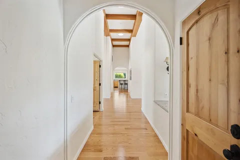 a view of a patio with table and chairs with wooden floor and fence