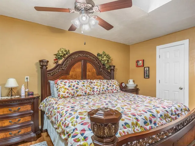a bedroom with a bed and a chandelier