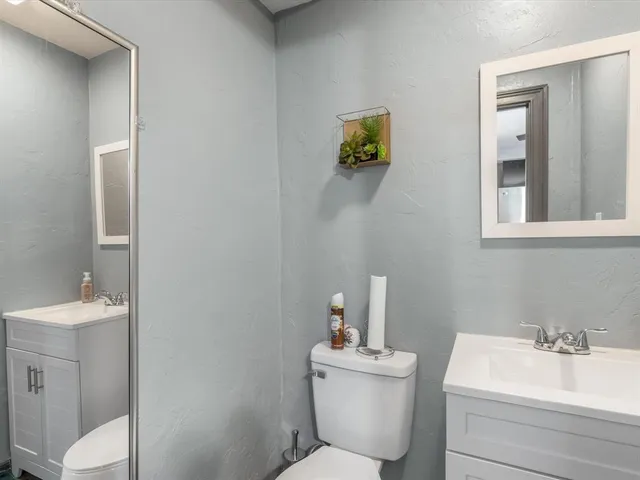 a bathroom with a sink mirror and toilet