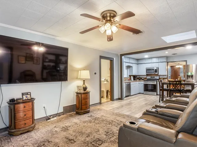 a living room with furniture and kitchen view